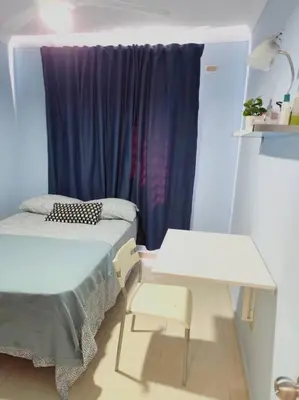 a room with a bed and a table and a window at Your Tropical HouseRD in La Francia