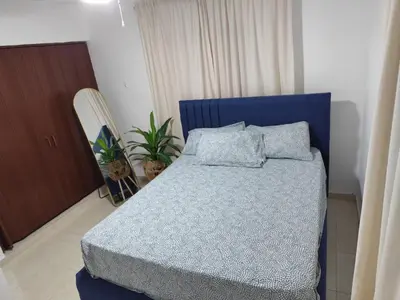 a bedroom with a blue bed with pillows on it at Your Tropical HouseRD in La Francia