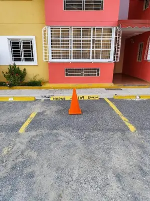 an orange cone in a parking lot in front of a building at Your Tropical HouseRD in La Francia