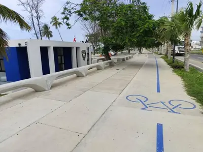 a sidewalk with a blue bike lane on it at Your Tropical HouseRD in La Francia