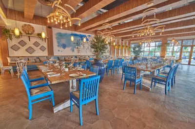 a restaurant with blue chairs and tables in a room at Bahia Principe Grand Punta Cana - All Inclusive in Punta Cana