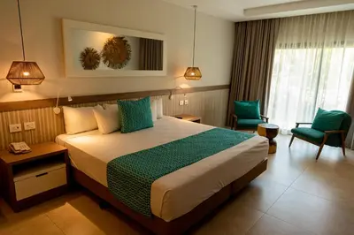 a hotel room with a bed and a chair at Bahia Principe Grand Punta Cana - All Inclusive in Punta Cana