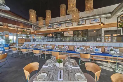 a dining room with tables and chairs and chandeliers at Bahia Principe Luxury Ambar - Adults Only All Inclusive in Punta Cana