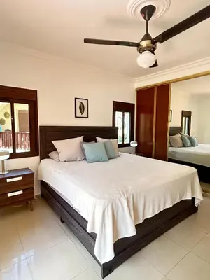 a bedroom with a large bed with a ceiling fan at Disfruta momentos inolvidables in Santo Domingo