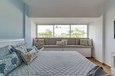 a bedroom with a large bed and a couch at El Retiro Juan Dolio Beach by Elital Luxury in Villas del Mar