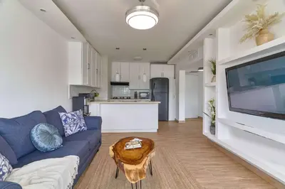 a living room with a blue couch and a table at El Retiro Juan Dolio Beach by Elital Luxury in Villas del Mar