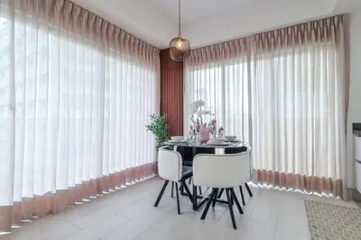 a dining room with a table and white chairs at Chic Centric 1BR Apt, King Bed in Los Prados