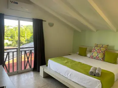 a bedroom with a bed and a balcony at Apartamento centro y playa in Las Terrenas