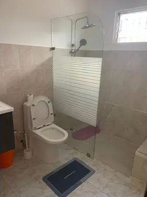 a bathroom with a shower and a toilet with a glass door at cabrera villa con vista al mar in Cabrera