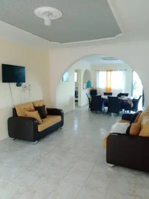 a living room with two couches and a dining room at cabrera villa con vista al mar in Cabrera