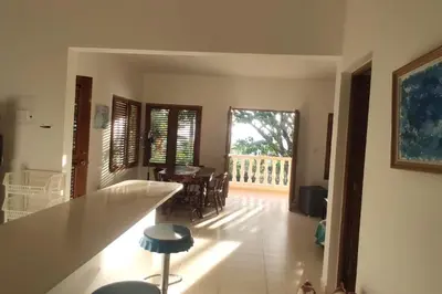 a kitchen and living room with a table and chairs at Villa LiMar in Río San Juan