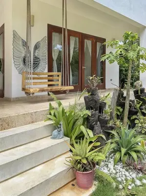 a porch of a house with a bench and plants at Oceanfront Villa with Staff, Private Pool, BBQ in Las Terrenas