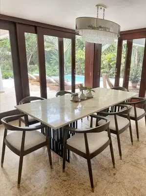 a dining table and chairs in a dining room at Oceanfront Villa with Staff, Private Pool, BBQ in Las Terrenas