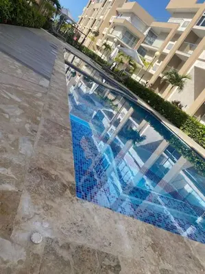 a swimming pool in front of a large building at Apartment in Playa Nueva Romana in San Pedro de Macorís