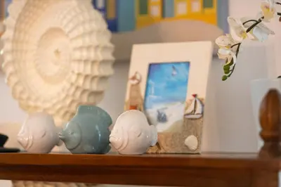a shelf with three figurines and a picture on it at Sunset Cove at Balcones in Las Terrenas