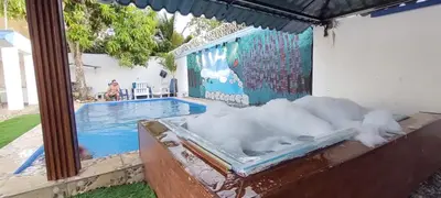a bath tub filled with snow next to a swimming pool at Villa Luz in Andrés