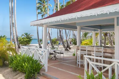 a restaurant on the beach with palm trees at Bahia Principe Grand La Romana - All Inclusive in La Romana
