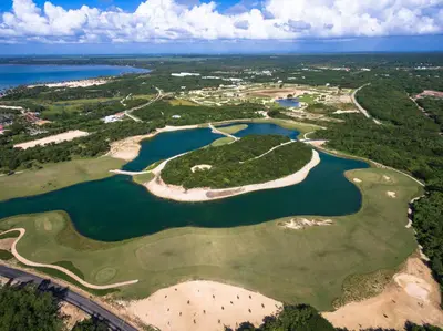 an aerial view of a golf course with a lake at Bahia Principe Grand La Romana - All Inclusive in La Romana