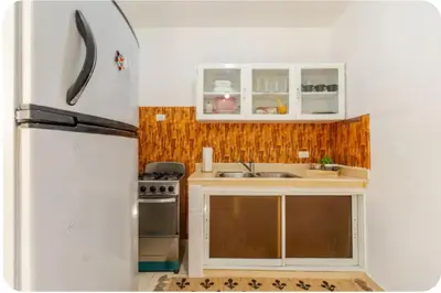 a kitchen with a refrigerator and a sink at Escape to Puerto Plata, Cozy 2BR Loft in Las Mercedes, 5 Min from Beaches in Isabel de Torres