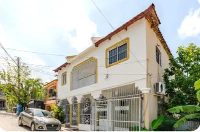 a house with a car parked in front of it at Escape to Puerto Plata, Cozy 2BR Loft in Las Mercedes, 5 Min from Beaches in Isabel de Torres
