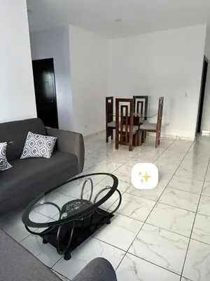 a living room with a couch and a glass table at Apartamentos victoria in Las Terrenas