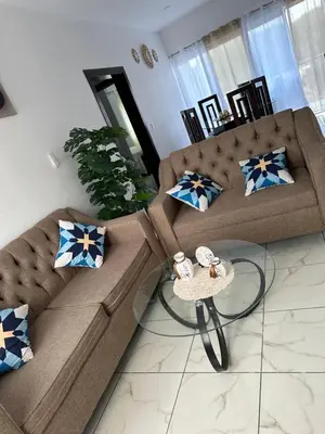 a living room with two brown couches and a table at Apartamentos victoria in Las Terrenas