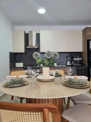 a kitchen with a table with plates and wine glasses at Luxury Apartment IZHA 202 in La Laguna