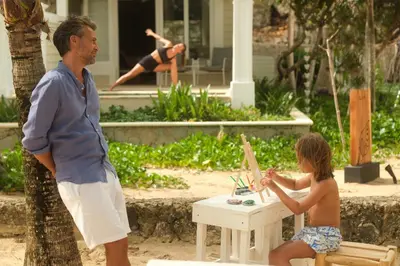 a man and a young girl sitting at a table at Cayo Levantado Resort - All Inclusive in Santa Bárbara de Samaná