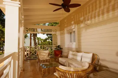 a porch with a couch and a ceiling fan at Cayo Levantado Resort - All Inclusive in Santa Bárbara de Samaná