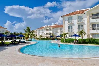 a person swimming in a pool at a resort at Beach Day at CadaquesCaribe Bayahibe in Bayahibe