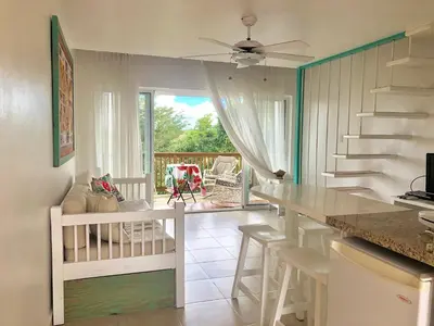 a kitchen and living room with a table and stairs at Beach Day at CadaquesCaribe Bayahibe in Bayahibe