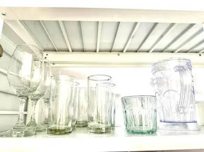 a group of glasses sitting on a shelf at Villa Olímpica Doble Vía in Marilópez