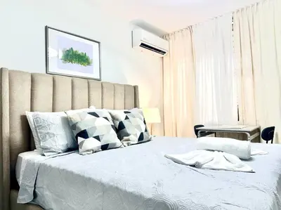a bedroom with a large bed with a white bedspread at Villa Olímpica Doble Vía in Marilópez