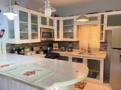 a kitchen with white cabinets and a counter top at Casa de adela in Cruce de Veragua