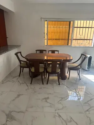 a dining room with a wooden table and chairs at Casa las Américas in La Alianza