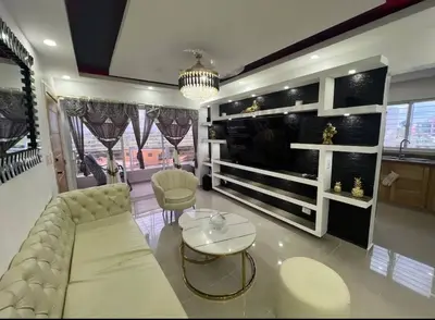 a living room with a couch and a table at Apartamento lujoso y cómodo in Santo Domingo
