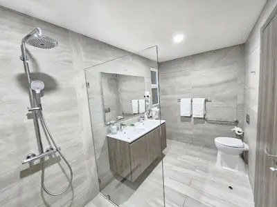 a bathroom with a shower and a sink and a toilet at Melody 2BDR Condo with Pool View in Coral Bay #2 in Punta Cana