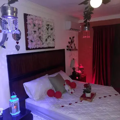 a bedroom with a bed with red balloons on it at Tropical 2 in La Hondonada