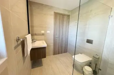 a bathroom with a shower and a toilet and a sink at Brand New beach and golf condo in Punta Cana in Punta Cana