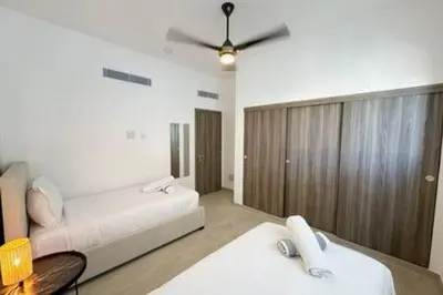 a bedroom with a bed and a ceiling fan at Brand New beach and golf condo in Punta Cana in Punta Cana