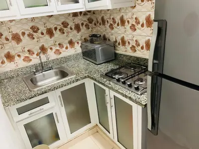 a small kitchen with a sink and a refrigerator at Apartamento Familiar in San Felipe de Puerto Plata