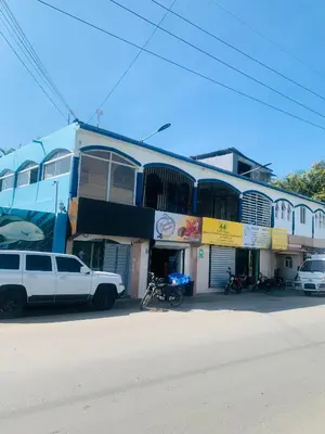 a white truck parked in front of a building at Apartamento Familiar in San Felipe de Puerto Plata