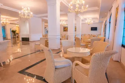 a dining room with tables and chairs and chandeliers at Eurostars Grand Cayacoa in Santa Bárbara de Samaná