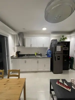 a kitchen with white cabinets and a stainless steel refrigerator at Tiny Home-El Pueblito in San Felipe de Puerto Plata
