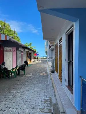 a cobblestone street in a town with benches and buildings at Tiny Home-El Pueblito in San Felipe de Puerto Plata