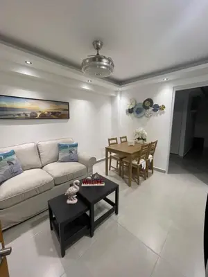 a living room with a couch and a table at Tiny Home-El Pueblito in San Felipe de Puerto Plata