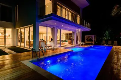 a house with a swimming pool at night at New private luxury villa in Punta Cana in Punta Cana