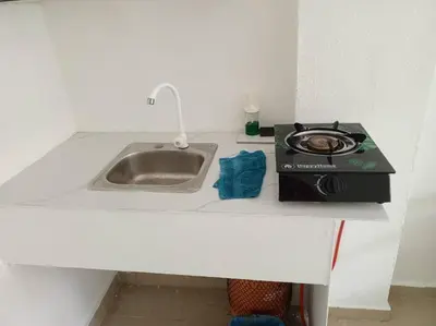 a kitchen counter with a stove and a sink at Acogedor apartamento entero in Mandinga