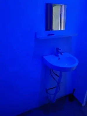 a bathroom with a white sink and a mirror at Confortable apartaestudio en Santo Domingo Este in Santo Domingo