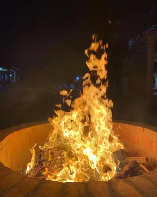 a fire in a fire pit at night at Villa las Rosas JP in Bayaguana